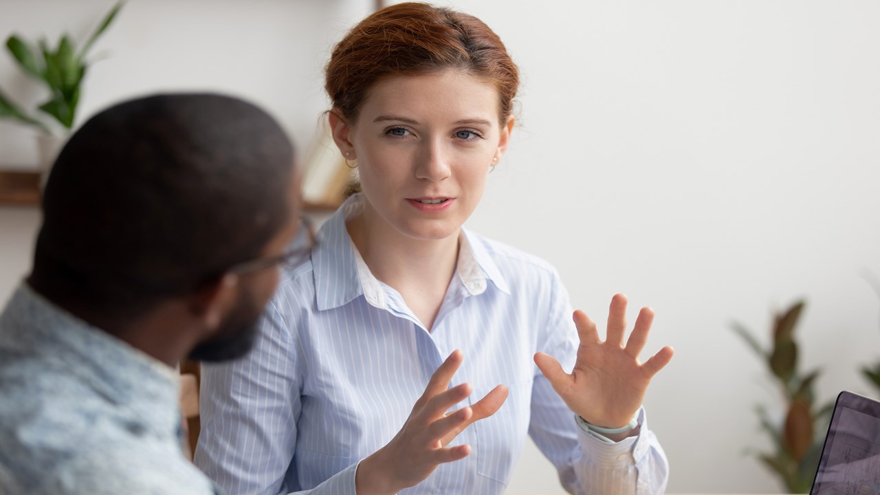 woman explaining and answering question for man