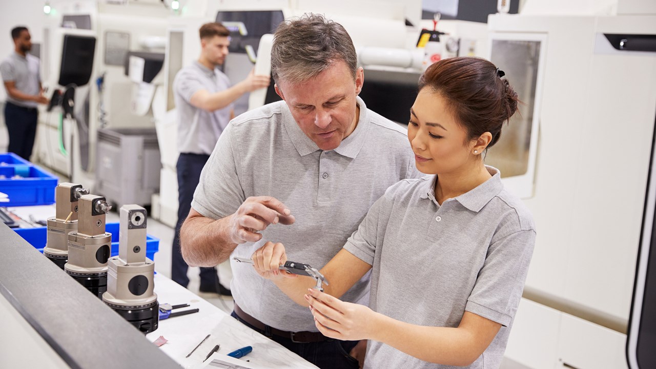 Male engineer working with female apprentice